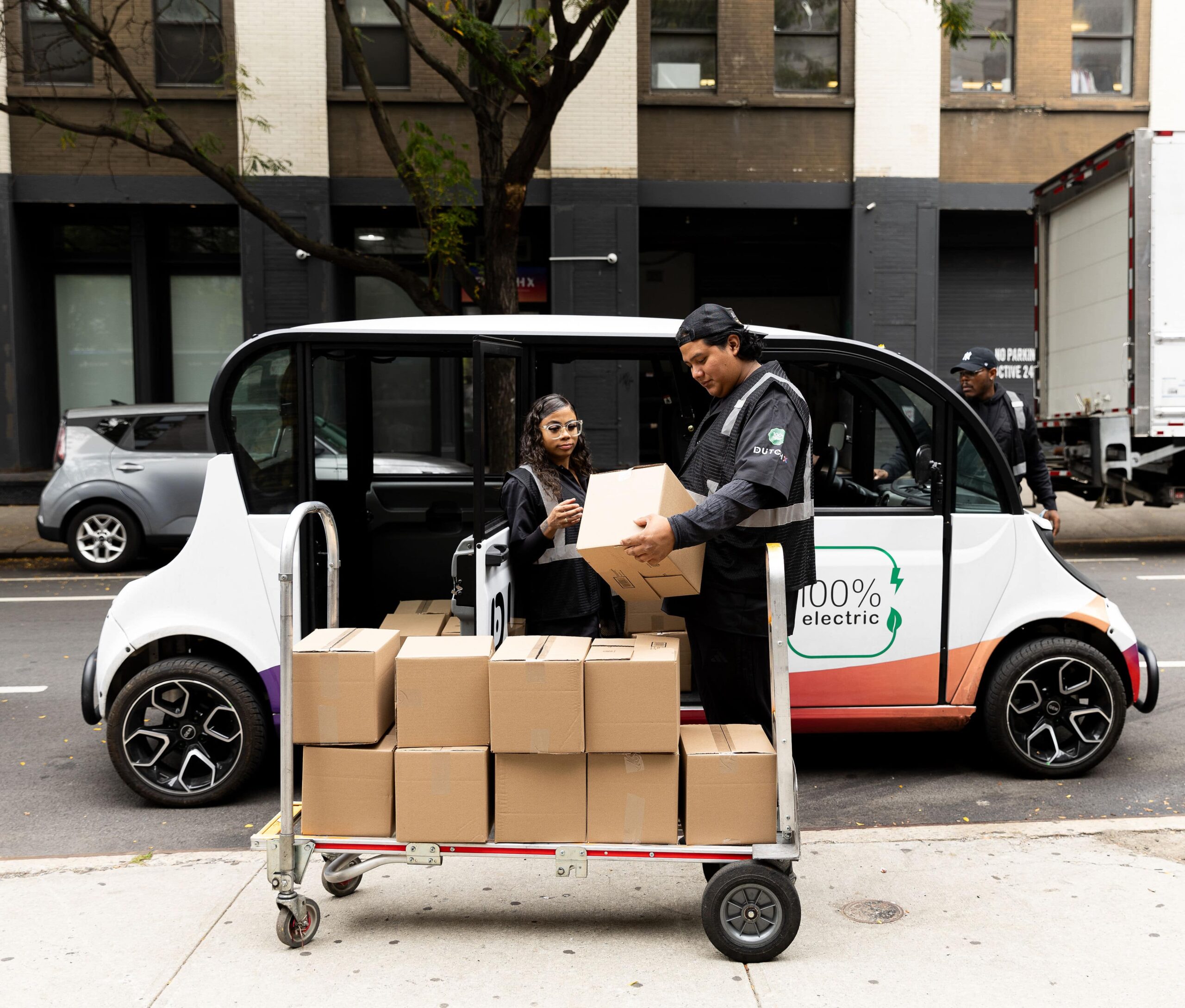DutchX workers loading boxes into electric vehicle