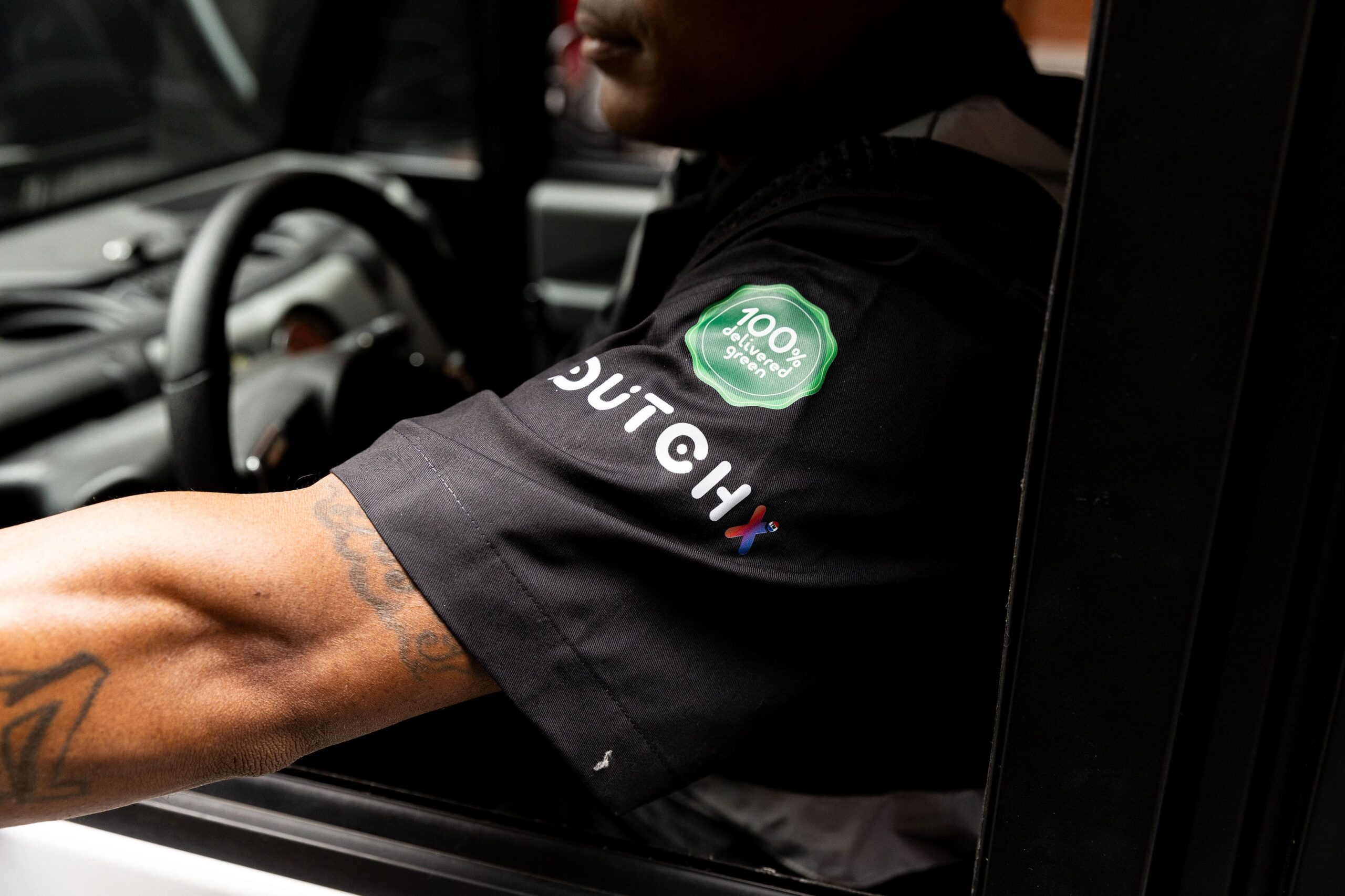 DutchX driver wearing branded uniform sleeve
